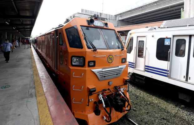UPGRADES ON TRACK The refleeting program of the Philippine National Railways (PNR) gets a boost with the acquisition of three diesel hydraulic locomotives and 15 passenger coaches from Indonesian manufacturer PT Inka. One of the newtrains is blessed by a priest (inset) and makes an inaugural run on Thursday. It arrives at De la Rosa Station in Makati City, next to another PT Inka train (painted white), which was shipped in 2019