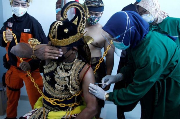 indonesia man being administered covid19 vaccine
