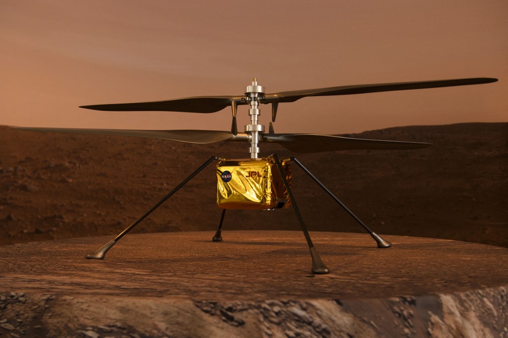 A full scale model of the experimental Ingenuity Mars Helicopter, which will be carried under the Mars 2020 Perseverance rover, is displayed at NASA's Jet Propulsion Laboratory (JPL) on February 16, 2021 in Pasadena, California. - The Mars exploration rover will search for signs of ancient microbial life and collect rock samples for future return to Earth to study the red planet's geology and climate, paving the way for human exploration. Perseverance also carries the experimental Ingenuity Mars Helicopter - which will attempt the first powered, controlled flight on another planet. (Photo by Patrick T. FALLON / AFP)