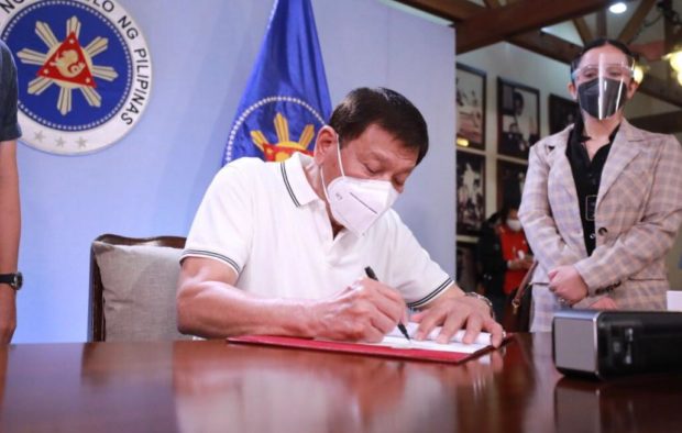 Duterte signs bill to hasten Covid-19 vaccine purchase; set up indemnity fund