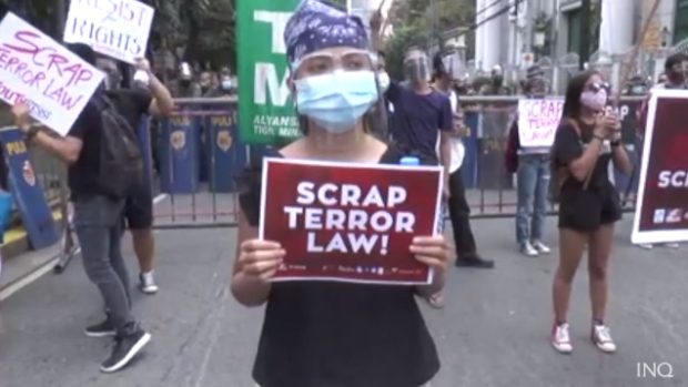 FILE PHOTO A protester flashes a placard calling for the scrapping of the anti-terror law, which critics say is being used to demonize individuals and groups critical of the government.