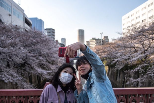 Sakura selfies: Tokyo enjoys cherry blossoms despite virus warning