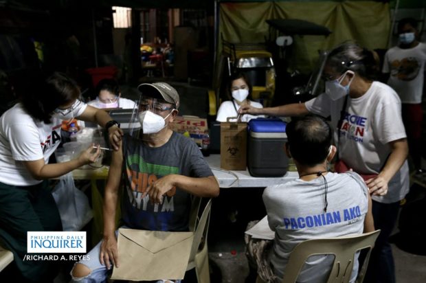 Elder residents receive the jab of Astrazeneca vaccine at Barangay 672 Zone 73 in Paco, Manila on March 28, 2021 during the start of vaccination for seniors citizens of the local government. RICHARD A. REYES / INQUIRER
