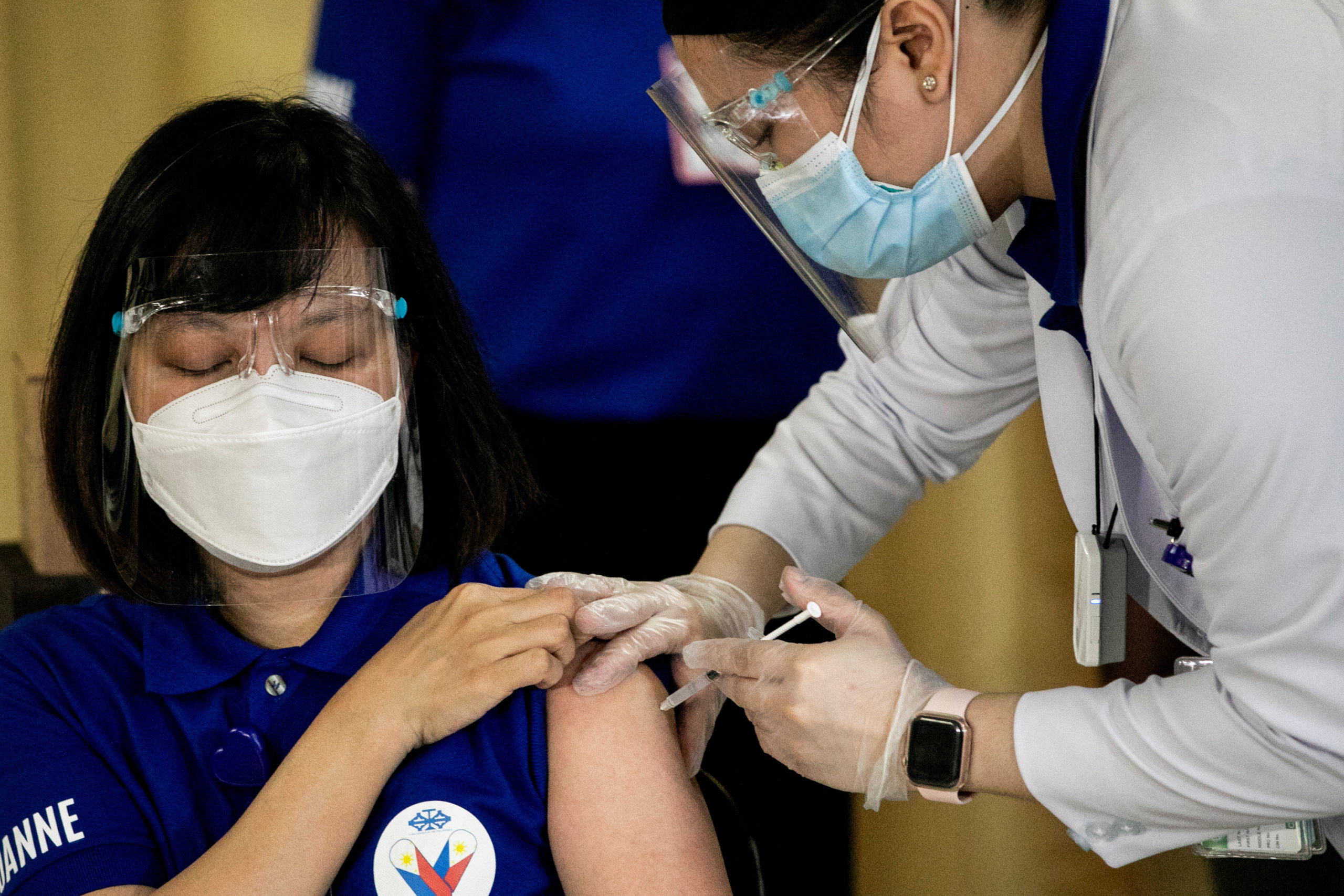 A health worker receives the Sinovac Biotech's Coronavac vaccine on the first day of the coronavirus disease (COVID-19) inoculation drive in the Philippines, at the Lung Center of the Philippines, Quezon City, Metro Manila, March 1, 2021. REUTERS/Eloisa Lopez