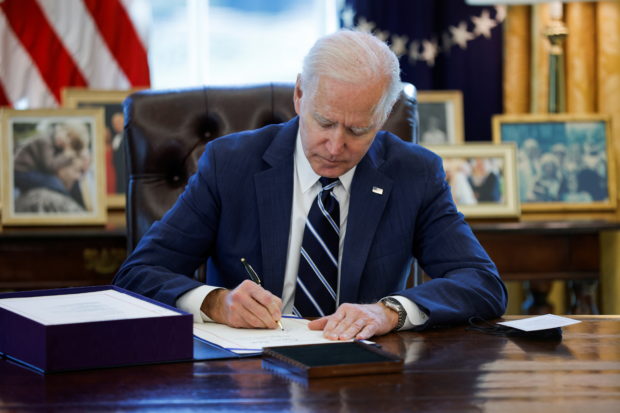 Biden signs $1.9 trillion stimulus bill into law on U.S. lockdown anniversary