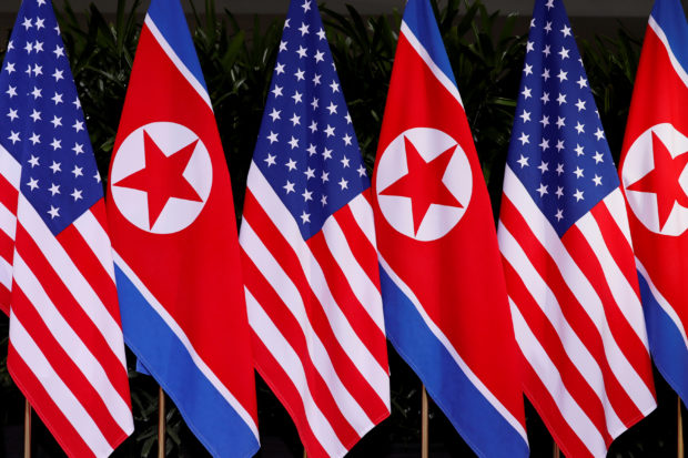 U.S. and North Korean national flags are seen at the Capella Hotel on Sentosa island in Singapore June 12, 2018. REUTERS/Jonathan Ernst/File Photo