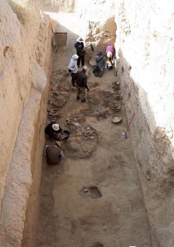 The remains of an 8th-century pantry, including a large jar believed to have contained wine and olive oil, excavated in Samarkand, Uzbekistan, in September 2019.