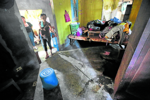 BLOODY RAID Imelda Evangelista, 55, on Wednesday points to the spot where her son, Ariel Evangelista, and his wife, Chai Lemita-Evangelista, were shot dead by police officers in Barangay Calayo, Nasugbu, Batangas. The Evangelista couple was among the nine activists killed in simultaneous police-military raids in the Southern Luzon region on Sunday. —GRIG C. MONTEGRANDE sunday cops police