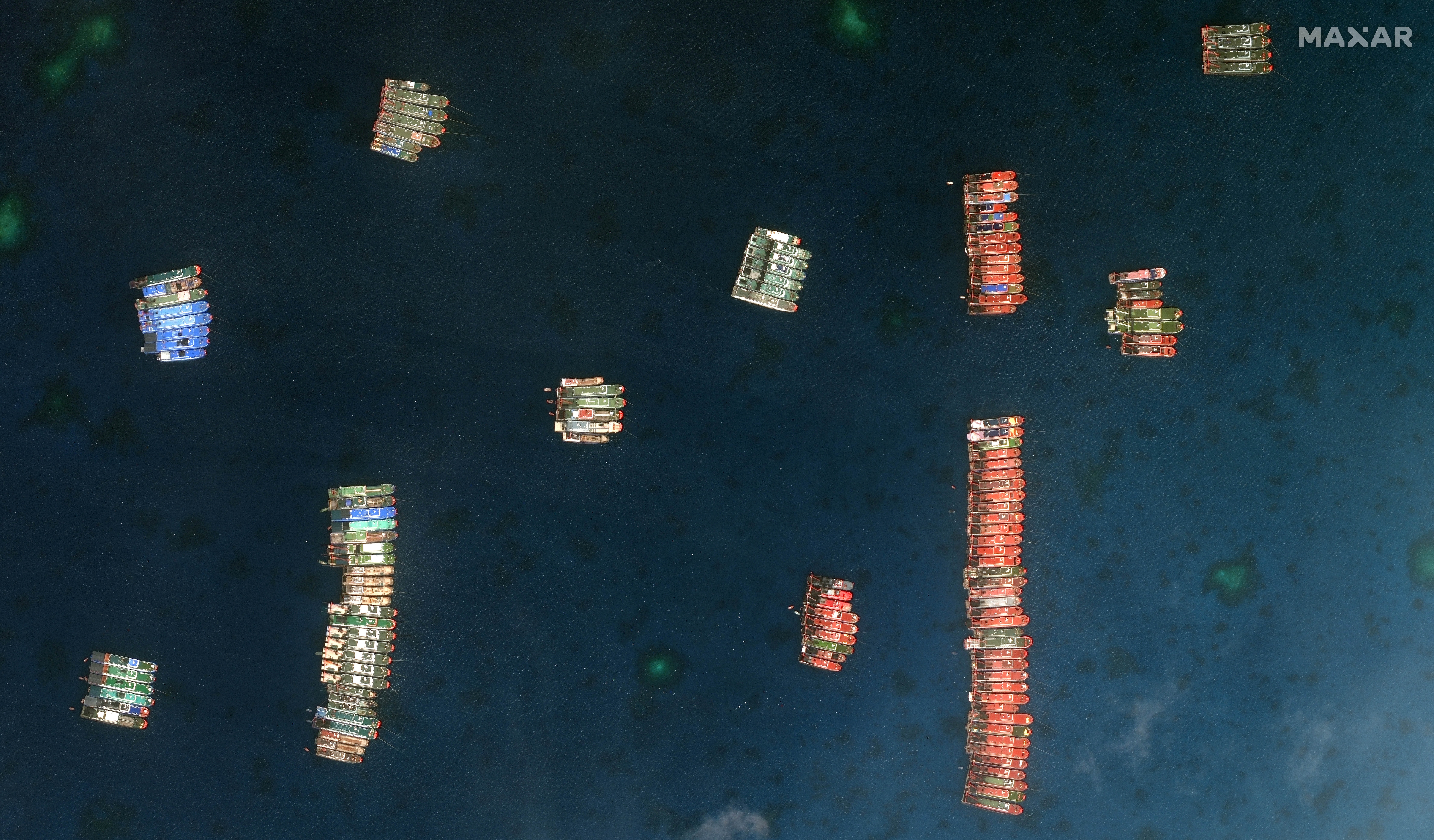 Closer view of one set of fishing vessels at Whitsun Reef, which Manila calls the Julian Felipe Reef, in this Maxar handout satellite image