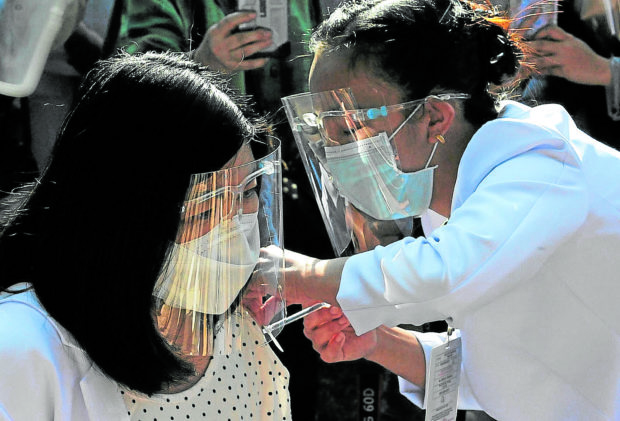 FIRST JAB A doctor in Baguio City gets her first dose of the COVID-19 vaccine produced by the Chinese company Sinovac Biotech during the vaccination drive launch in the Cordillera region on March 5. —EV ESPIRITU