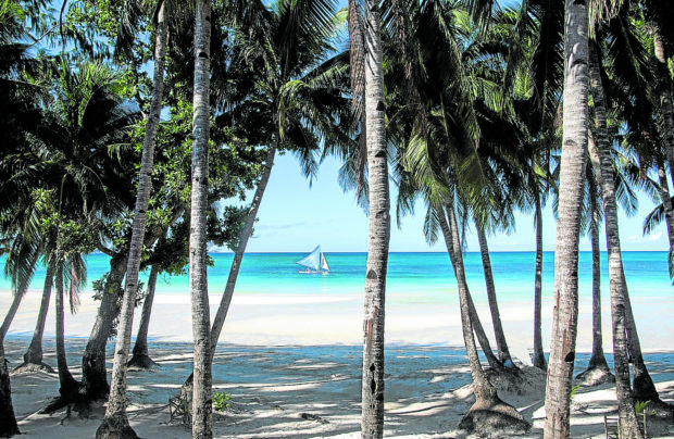 REHAB RESULT Tourists enjoy a wider and cleaner beach after the six-month closure of Boracay in 2018. The government task force overseeing the full rehabilitation of the resort island in Aklan province says it needs more time to finish its mandate. —JACK JARILLA