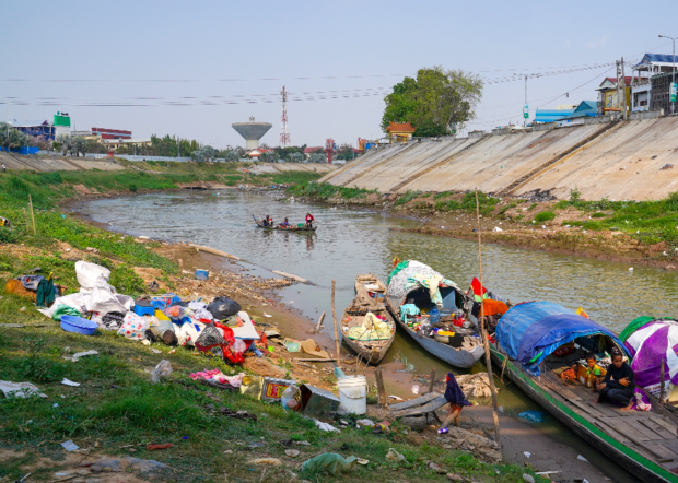 FILE PHOTO: Fishermen dock their boats on a river branching off Bassac River, a distributary of the Tonle Sap and Mekong River, during low water levels near Phnom Penh, Cambodia, February 22, 2021