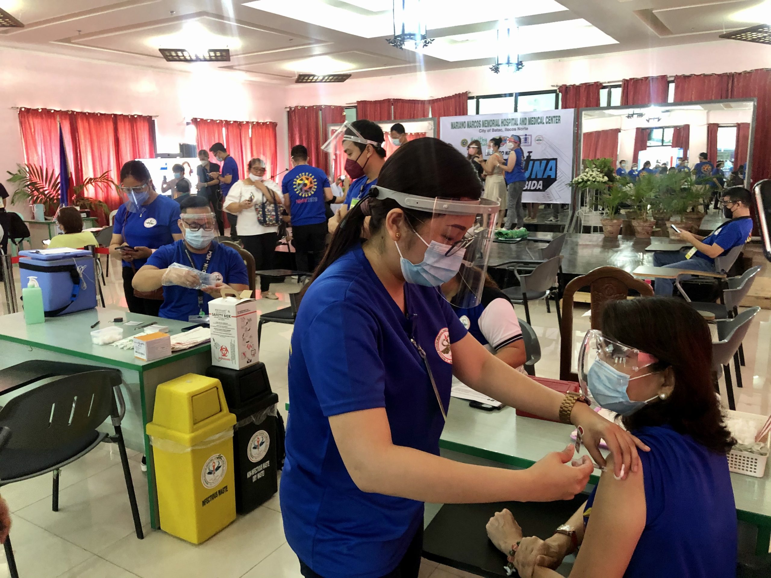 Medical staff administer vaccines to hospital workers in Ilocos Norte