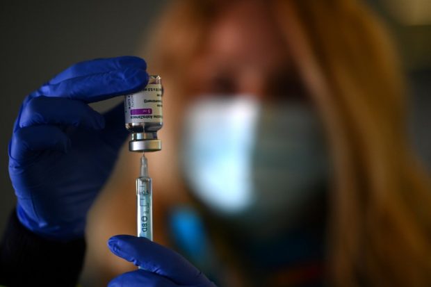 A health worker prepares a dose of the AstraZeneca/Oxford vaccine at a coronavirus vaccination centre at the Wanda Metropolitano stadium in Madrid on March 24, 2021. - Spain raised the maximum age limit for people to receive the AstraZeneca vaccine, which has faced setbacks in Europe due to safety concerns, from 55 to 65. 