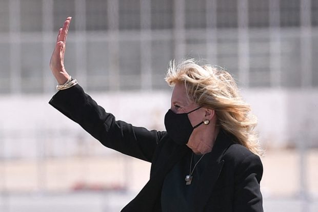 US First Lady Jill Biden waves as she boards a plane before departing from Meadows Field Airport in Bakersfield, California on April 1, 2021