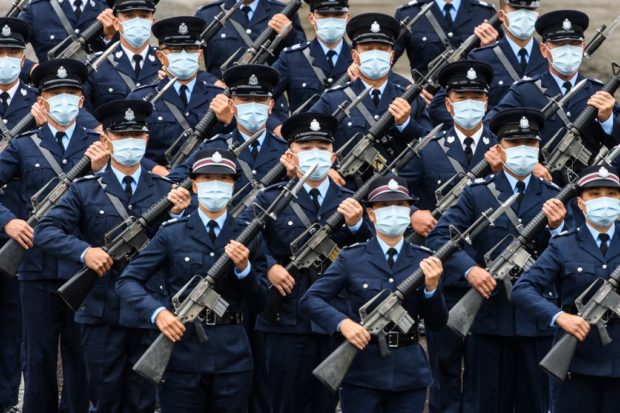 Police officers perform a new goose-stepping march, the same style used by police and troops on the Chinese mainland, at the city's police college during an open day to mark the National Security Education Day in Hong Kong on April 15, 2021