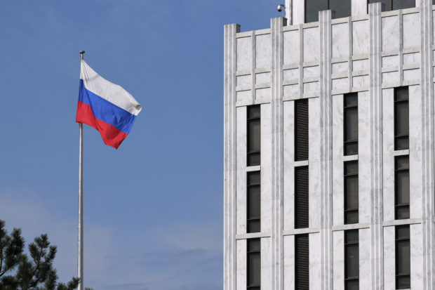 The Russian flag flies at the embassy's compound in Washington, DC,  on April 15, 2021. - The US announced sanctions against Russia on April 15, 2021, and the expulsion of 10 diplomats in retaliation for what Washington says is the Kremlin's US election interference, a massive cyber attack and other hostile activity. President Joe Biden ordered a widening of restrictions on US banks trading in Russian government debt, expelled 10 diplomats who include alleged spies, and sanctioned 32 individuals alleged to have tried to meddle in the 2020 presidential election, the White House said. 