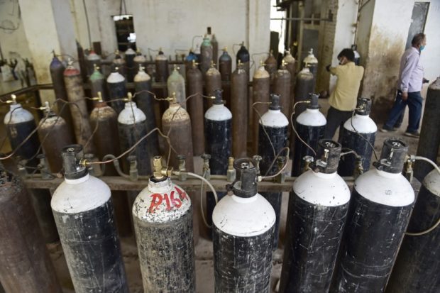 A worker prepares to fill medical oxygen cylinders for hospital use on Covid-19 coronavirus patients at a plant in Allahabad on April 17, 2021.