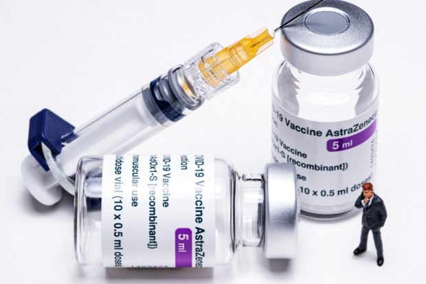This file photo illustration taken on March 11, 2021  shows vials of the AstraZeneca Covid-19 vaccine, a syringe and a figurine in Paris. - Canadian health authorities said April 17, 2021 the country has recorded a second case of rare but serious blood clotting linked to AstraZeneca's Covid-19 vaccine, but still recommend the shot for use. The patient, who lives in the western province of Alberta and received a version of the AstraZeneca vaccine supplied by the Serum Institute of India, "has received treatment and is recovering," Canadian health authorities wrote on Twitter. 