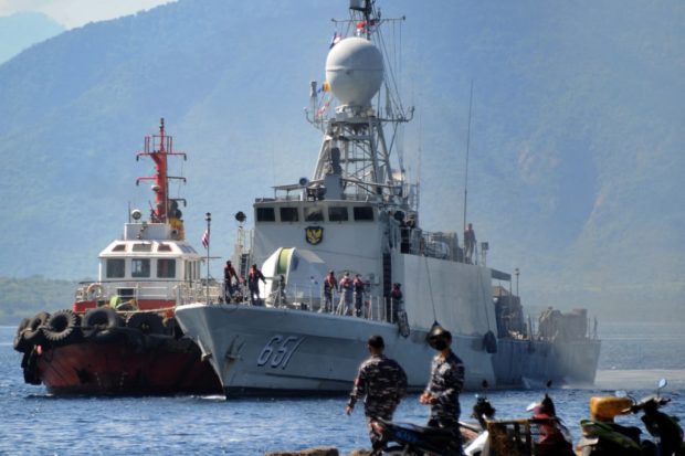 The Indonesian Navy patrol boat KRI Singa (651) prepares to load provisions at the naval base in Banyuwangi, East Java province, on April 24, 2021, as the military continues search operations off the coast of Bali for the Navy's KRI Nanggala (402) submarine that went missing April 21 during a training exercise