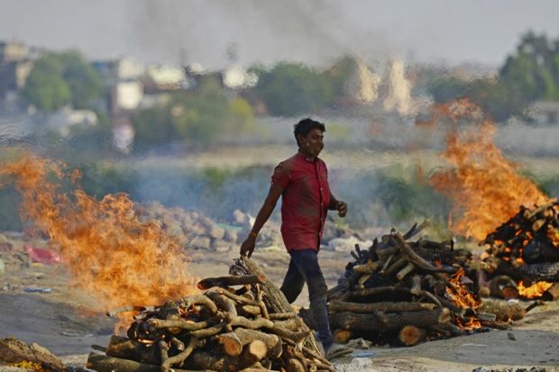 Funeral pyres burn as the last rites are performed of the patients who died of the Covid-19 coronavirus at a cremation ground in Allahabad on April 27, 2021