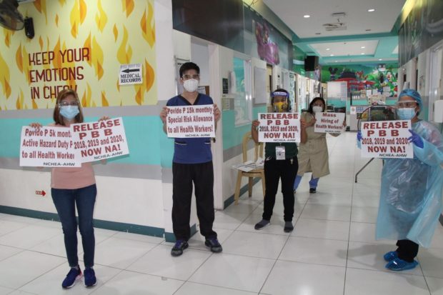 LOOK: Health workers from different public hospitals staged a simultaneous noise barrage and protest from wards to demand the immediate release of withheld benefits and urgent mass hiring of health workers to handle Covid-19 patients.