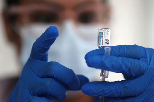 A nurse draws from a vial of Johnson & Johnson coronavirus disease (COVID-19) vaccine, in Los Angeles