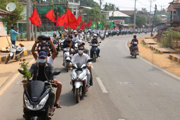 People take part in a motorcycle parade during a protest against the military coup, in Launglon township