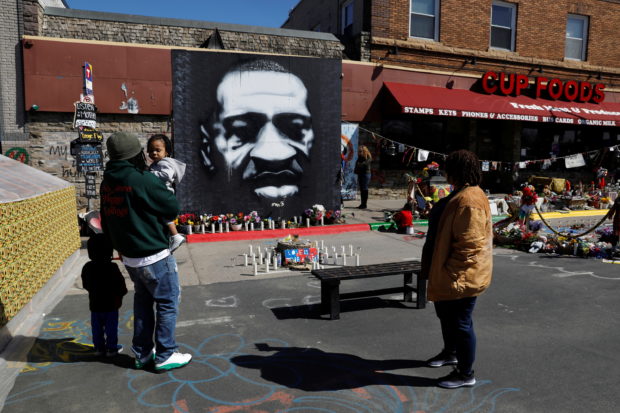 Visitors pay their respects at George Floyd Square while the fourth day of trial continues for Derek Chauvin, who is facing murder charges in the death of George Floyd, in Minneapolis, Minnesota, U.S., April 1, 2021. 