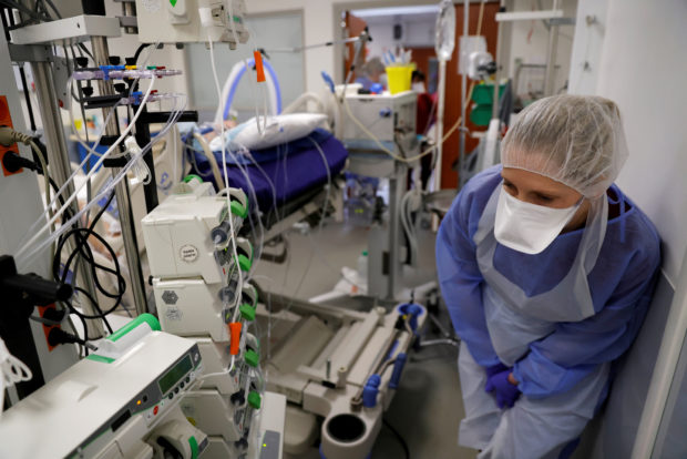 A medical worker, wearing protective gear, works in the Intensive Care Unit (ICU) where patients suffering from the coronavirus disease (COVID-19) are treated at Cambrai hospital, France, April 1, 2021