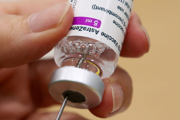 A medical worker prepares a dose of Oxford/AstraZeneca's COVID-19 vaccine at a vaccination centre in Antwerp, Belgium March 18, 2021