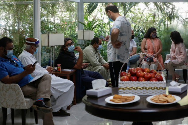 Residents sit in a waiting area after getting a commercial dose of Russia's Sputnik V coronavirus disease (COVID-19) vaccine, at a private hospital in Karachi, Pakistan April 4, 2021. REUTERS/Akhtar Soomro