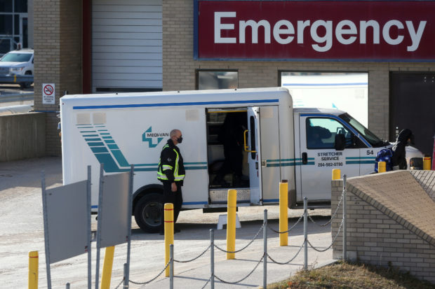 A health care worker in a surgical mask helps unload a stretcher service vehicle at St. Boniface Hospital, which is a reported site of the coronavirus disease (COVID-19) outbreak according to local media, in Winnipeg, Manitoba, Canada, November 1, 2020. 