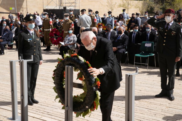 Israeli President Reuven Rivlin pays tribute during a wreath-laying ceremony marking Holocaust Remembrance Day at Warsaw Ghetto Square at Yad Vashem memorial in Jerusalem, April 8, 2021