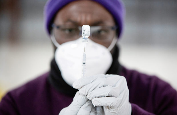 Safeway pharmacy manager Kel Fanny draws up a COVID-19 vaccine at a coronavirus disease (COVID-19) mass vaccination site at the Clark County Event Center at the Fairgrounds in Ridgefield, Washington, U.S. January 27, 2021