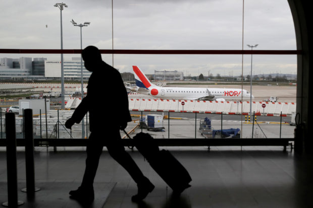 A man walks inside a Terminal at Paris Charles de Gaulle airport in Roissy near Paris as France closed its borders to travellers outside European Union due to restrictions against the spread of the coronavirus disease (COVID-19) in France, February 5, 2021