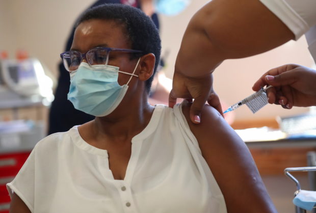 FILE PHOTO: A healthcare worker receives the Johnson and Johnson coronavirus disease (COVID-19) vaccination  at Khayelitsha Hospital near Cape Town, South Africa, February 17,  2021