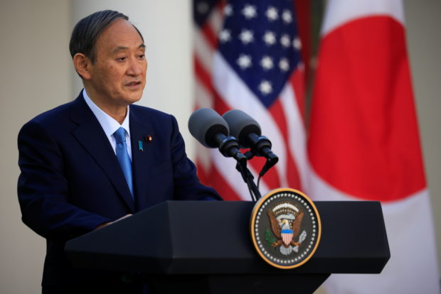 Japan's Prime Minister Yoshihide Suga addresses a joint news conference with U.S. President Joe Biden in the Rose Garden at the White House in Washington, U.S., April 16, 2021