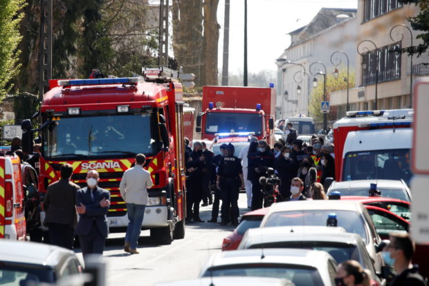 Police officers secure the area where an attacker stabbed a female police administrative worker, in Rambouillet, near Paris, France, April 23, 2021. REUTERS/Gonzalo Fuentes