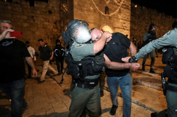 Israeli police detain a Palestinian at Jerusalem's Old City during clashes, as the Muslim holy fasting month of Ramadan continues, in Jerusalem