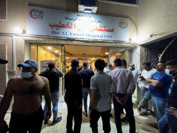 People gather at Ibn Khatib hospital after a fire caused by an oxygen tank explosion in Baghdad