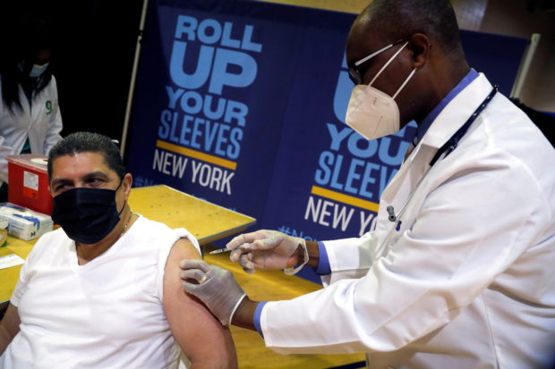Eugenio Brito, vice president of Bodegas of America, receives a Pfizer vaccination shot amid the coronavirus disease (COVID-19) pandemic, in the Harlem section of Manhattan in New York City, New York, U.S., April 23, 2021. REUTERS/Mike Segar/Pool/File Photo