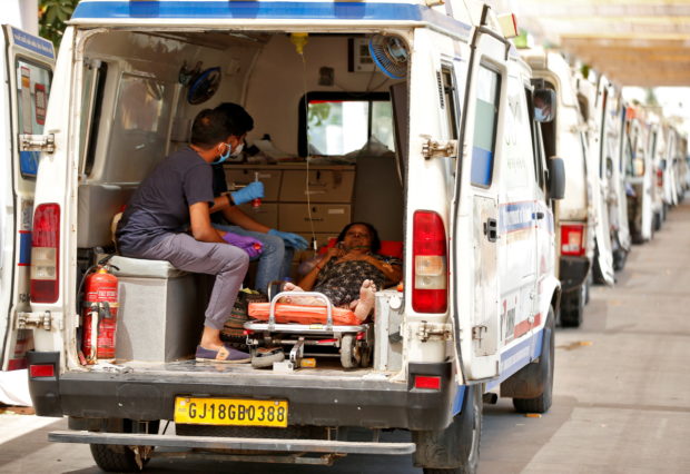 A woman with breathing problem waits inside an ambulance for her turn to enter a COVID-19 hospital for treatment, amidst the spread of the coronavirus disease (COVID-19) in Ahmedabad, India, April 28, 2021