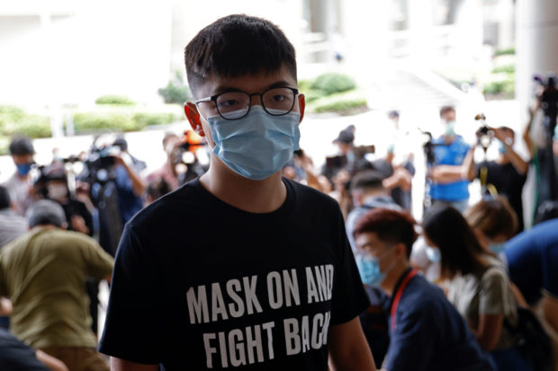 Pro-democracy activist Joshua Wong arrives at the Eastern Magistrates' Courts over illegal assembly and violation of an emergency law banning face coverings last year, in Hong Kong