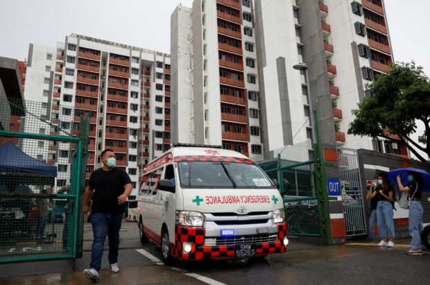 An ambulance carrying a migrant worker leaves Westlite Woodlands dormitory after workers were tested positive for the coronavirus disease (COVID-19), in Singapore