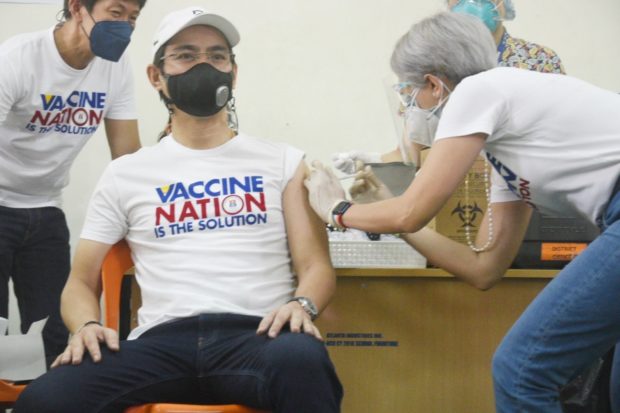 Manila Mayor Isko Moreno gets his COVID-19 vaccine administered by Vice Mayor Honey Lacuna, a doctor