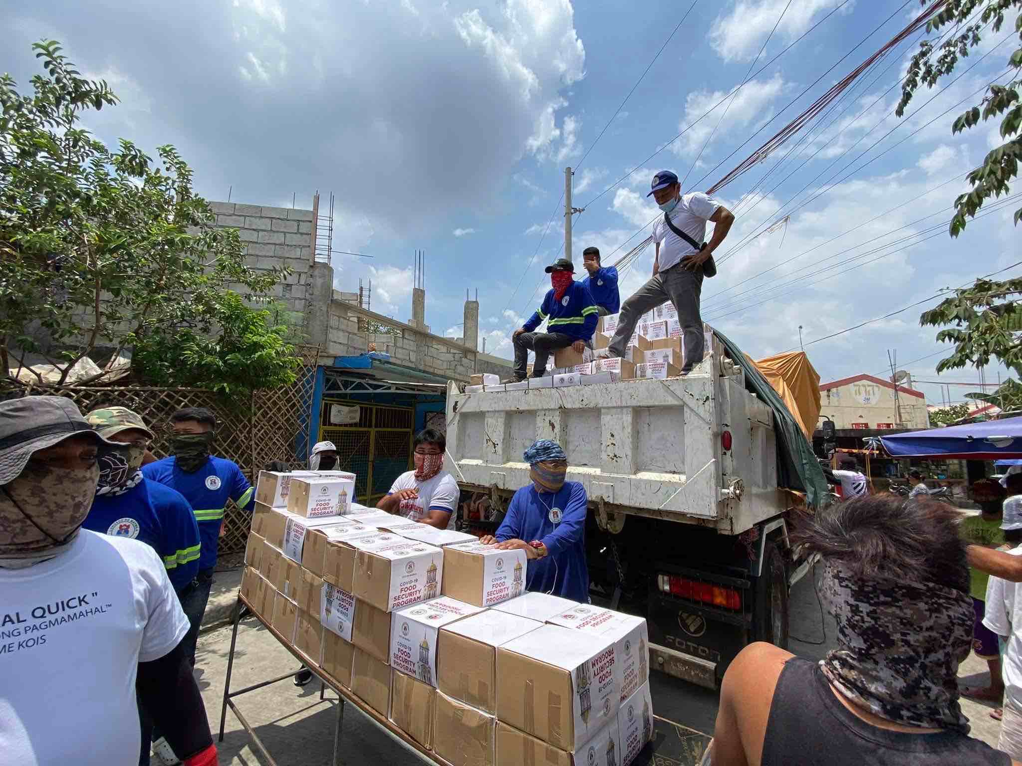 Personnel of the Manila City government's Department of Public Services deliver food boxes to relocated residents in Cavite and Bulacan. 