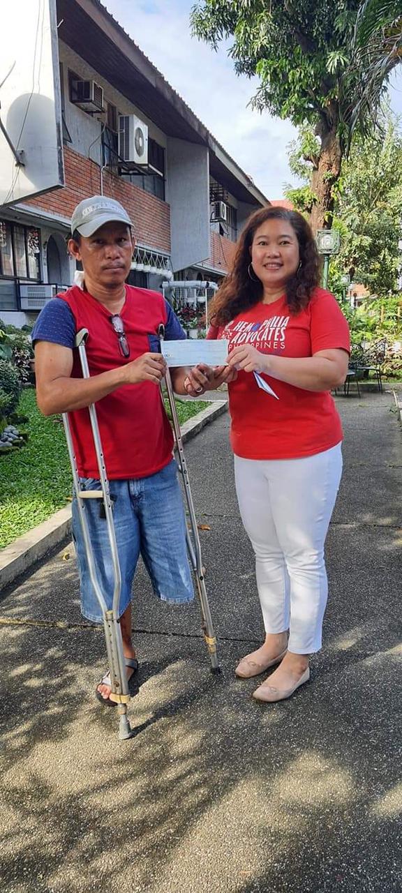 Andrea Trinidad, president of Hemophilia Advocates-Philippines, awards $700 Micro-Enterprise Grant to Rolly Marsula who has Hemophilia A