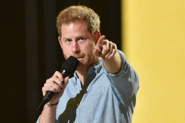 Co-Chair Britain's Prince Harry, Duke of Sussex, gestures as he speaks onstage during the taping of the "Vax Live" fundraising concert at SoFi Stadium in Inglewood, California, on May 2, 2021. - The fundraising concert "Vax Live: The Concert To Reunite The World", put on by international advocacy organization Global Citizen, is pushing businesses to "donate dollars for doses," and for G7 governments to share excess vaccines. The concert will be pre-taped on May 2 in Los Angeles, and will stream on YouTube along with American television networks ABC and CBS on May 8. (Photo by VALERIE MACON / AFP)