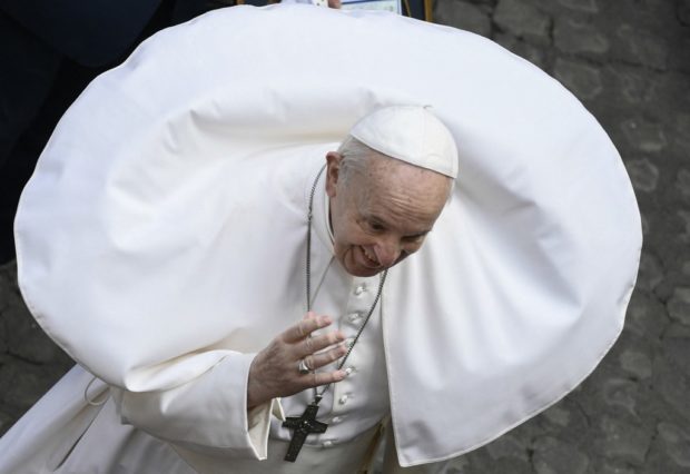 A gust of wind lifts Pope Francis' cassock during his a weekly outdoors general audience with the public on May 19, 2021 at San Damaso courtyard in The Vatican